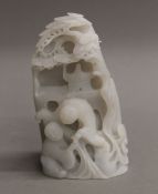 A Chinese white jade carved figural group. 11 cm high.