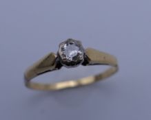 An 18 ct gold diamond solitaire ring. Ring size N. 2.2 grammes total weight.
