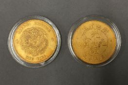 Two Chinese gilt coins, in cases. 4 cm diameter.