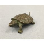 A small bronze model of a turtle. 5.5 cm long.