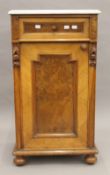 A Victorian marble topped walnut pot cupboard. 83 cm high x 46 cm wide.