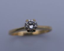 An 18 ct gold diamond solitaire ring. Ring size G/H. 1.8 grammes total weight.