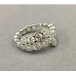 A silver cubic zirconia band ring.