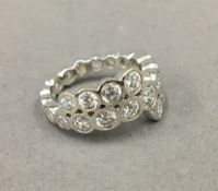 A silver cubic zirconia band ring.