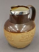 A silver mounted Doulton Lambeth harvest jug. 18 cm high.