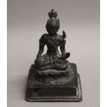 An 18th century patinated bronze model of buddha. 13 cm high.
