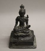 An 18th century patinated bronze model of buddha. 13 cm high.