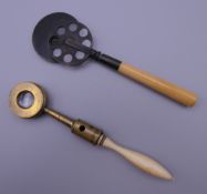 Two 19th century optical lenses on ivory handles. The largest 11.5 cm long.