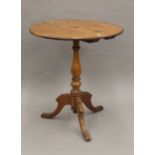A tripod table with 19th century base and later top. 65 cm diameter.
