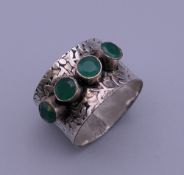 A silver green stone set ring. Ring size O/P/Q.