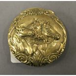 A brass vesta depicting horses. 4.5 cm diameter.
