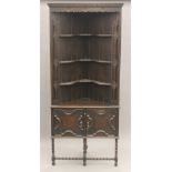 An early 20th century oak barley twist standing corner cabinet. 191.5 cm high.