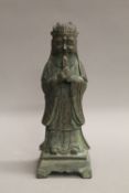 A Chinese bronze figure of an attendant. 24 cm high.