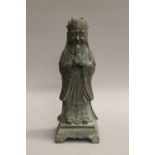 A Chinese bronze figure of an attendant. 24 cm high.
