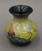 A small modern Moorcroft Hypericum pattern vase. 9 cm high.