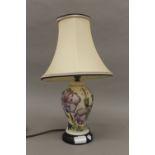A Moorcroft Meadow Cranesbill table lamp by Alicia Amison, with matching silk shade.
