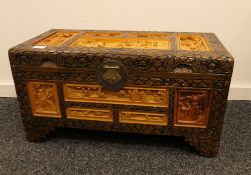 A carved Chinese camphor wood chest. 69 cm wide.
