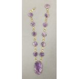 A 14 ct gold mounted amethyst pendant necklace. 38 cm long.