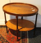 An early 20th century walnut oval tea table. 64.5 cm long.