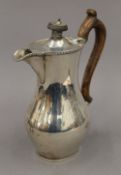 A silver hot water jug. 18 cm high. 8.9 troy ounces total weight.