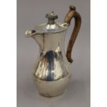 A silver hot water jug. 18 cm high. 8.9 troy ounces total weight.