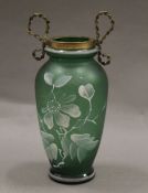 A Victorian blown and hand painted green glass vase with brass bow collar. 14.5 cm high.