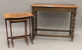 A nest of two side tables and an oak table. The latter 88.5 cm long.
