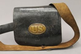 A 19th century United States Army leather bag, with fitted interior and brass badges. 23.5 cm wide.