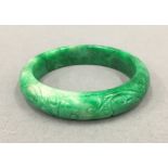A Chinese carved jade bangle. 7.5 cm diameter.