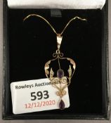 An Edwardian 9 ct gold amethyst and seed pearl pendant, on a 9 ct gold chain. The pendant 4 cm high.