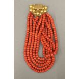 A string of large coral beads with an 18 ct gold clasp. 41 cm long.