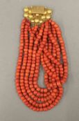 A string of large coral beads with an 18 ct gold clasp. 41 cm long.