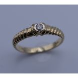 A 9 ct gold diamond solitaire ring. Ring size N. 2.1 grammes total weight.