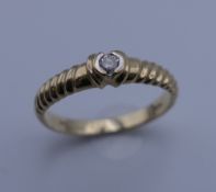 A 9 ct gold diamond solitaire ring. Ring size N. 2.1 grammes total weight.