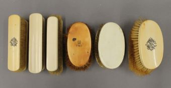 A quantity of Victorian ivory dressing table brushes.