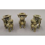 Three 19th century Eastern bronze candlesticks. Each approximately 9.5 cm high.