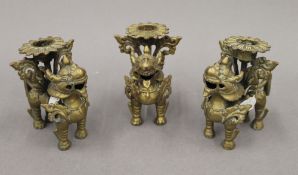 Three 19th century Eastern bronze candlesticks. Each approximately 9.5 cm high.