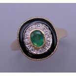An Art Deco style 9 ct gold emerald, diamond and onyx ring. Ring size O/P. 3.8 grammes total weight.