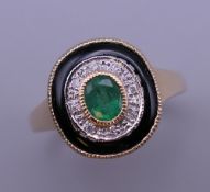 An Art Deco style 9 ct gold emerald, diamond and onyx ring. Ring size O/P. 3.8 grammes total weight.