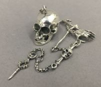 A watch chain set with skull fob. The skull 4 cm long.