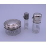 Two silver topped scent bottles and a pot. The largest 7 cm high.