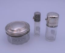 Two silver topped scent bottles and a pot. The largest 7 cm high.