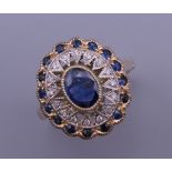 An Art Deco style 9 ct gold oval sapphire and diamond ring. Ring size N/O. 4.3 grammes total weight.