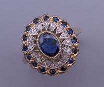 An Art Deco style 9 ct gold oval sapphire and diamond ring. Ring size N/O. 4.3 grammes total weight.