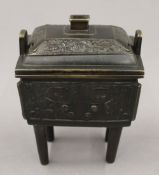 A 19th century Chinese bronze censer and cover on four legs,