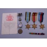 A small quantity of militaria, including three WWII medals, a lighter, badges, etc.