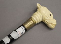 A bone handle walking stick, the handle formed as a dog's head. 92.5 cm long.