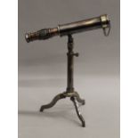 A small telescope and stand. 23 cm long.