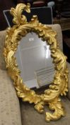 A modern gilt framed wall glass. 88 cm high.