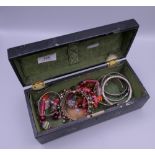 A quantity of miscellaneous jewellery in a lacquered box.